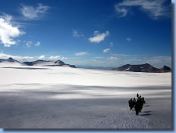 Group of riders on icefield on Sollipulli horse back  trek in the chilean Andes